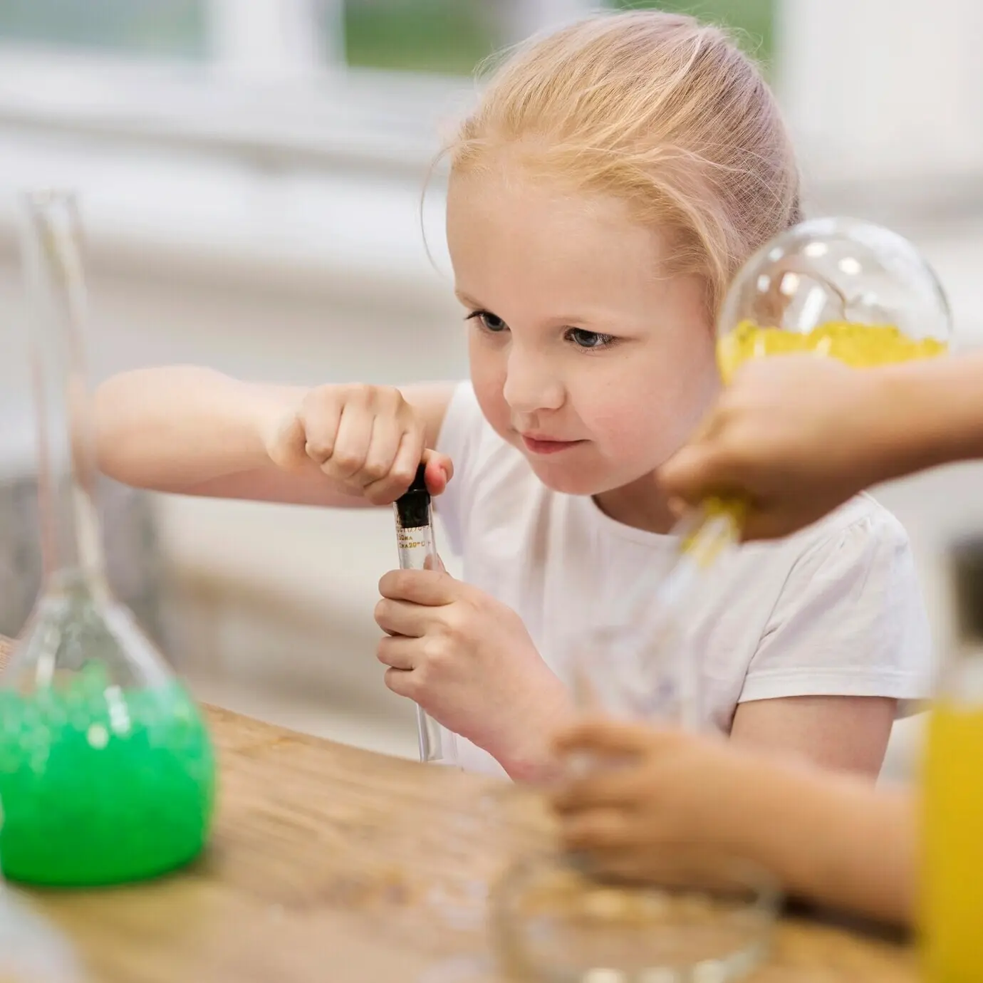 Вид сверху: девочка на уроке по науке.